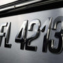 Metallic badge with 'FL4213' on a reflective surface