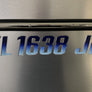 Metallic surface with engraved text 'FL1638 JB'