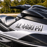 Close-up of a jet ski with a license plate in a tropical setting