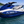 Blue and white jet ski on a body of water with a clear sky.