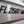Metallic surface with 'FL 2597 AR' text and a red and blue stripe.